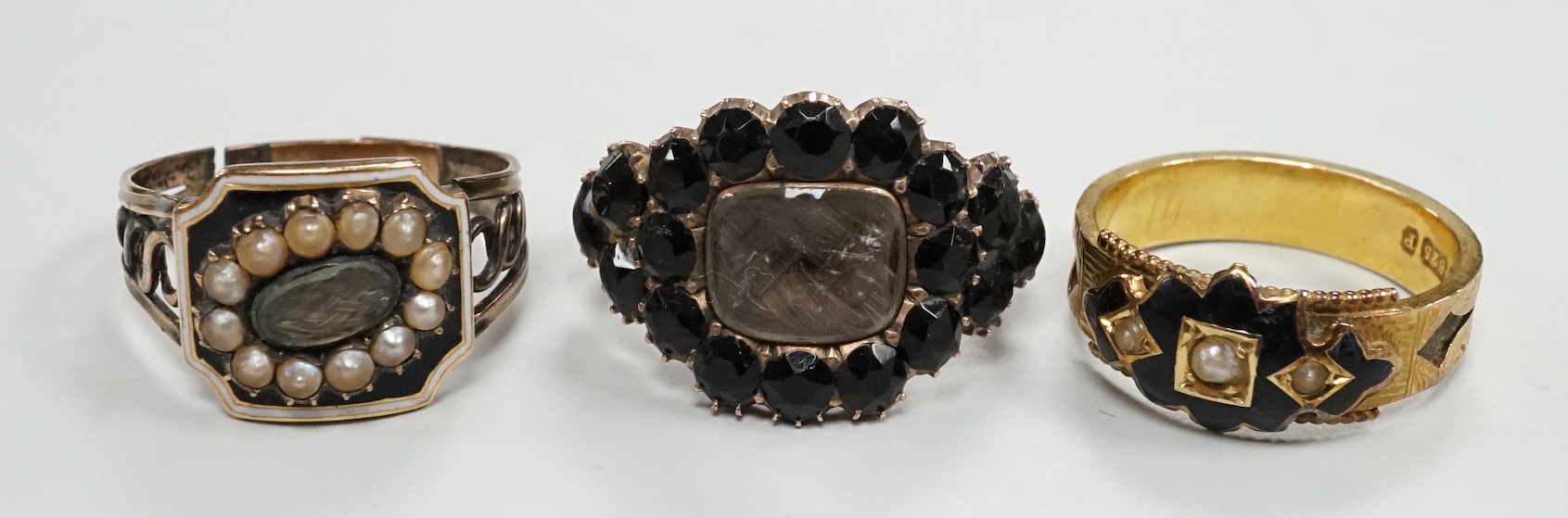 Three assorted Georgian mourning rings, including a 15ct gold, seed pearl and black enamel.